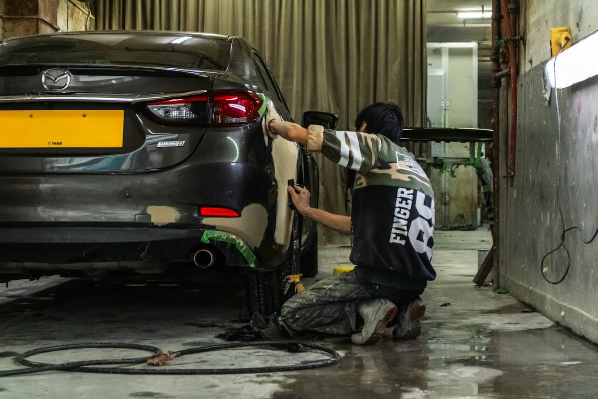 Mechanic working on a car in a body shop