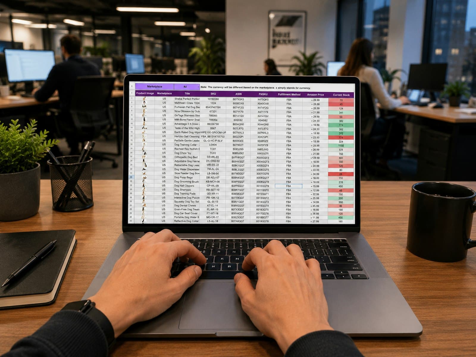 Hands typing on a laptop that shows a spreadsheet of rows