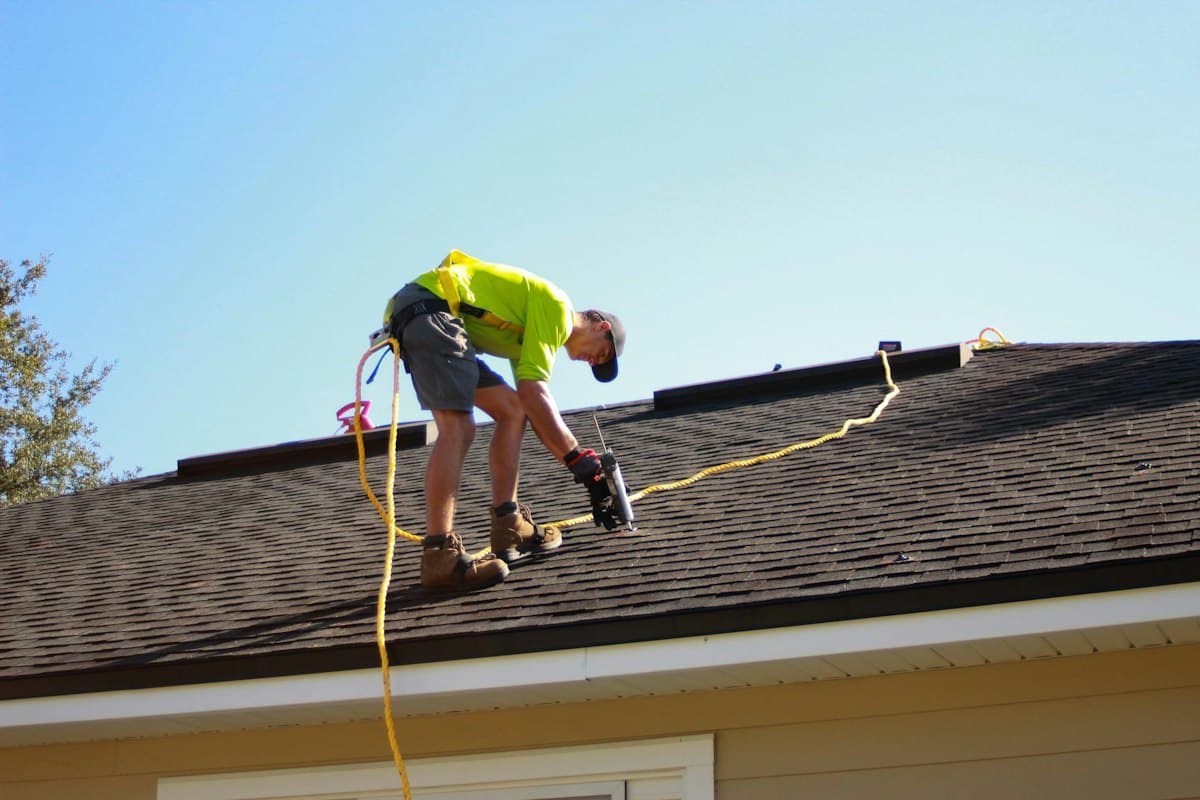 Roofer working on a shingle roof