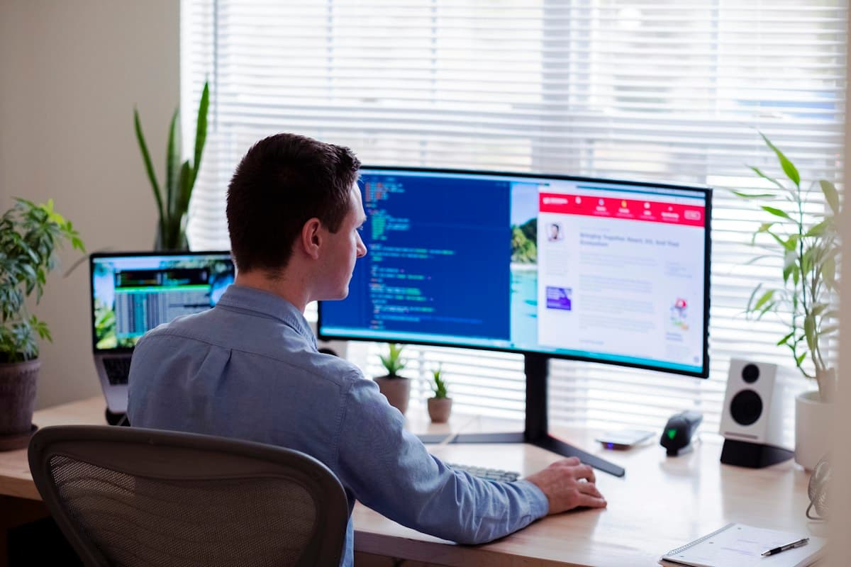Web designer working at a wide monitor
